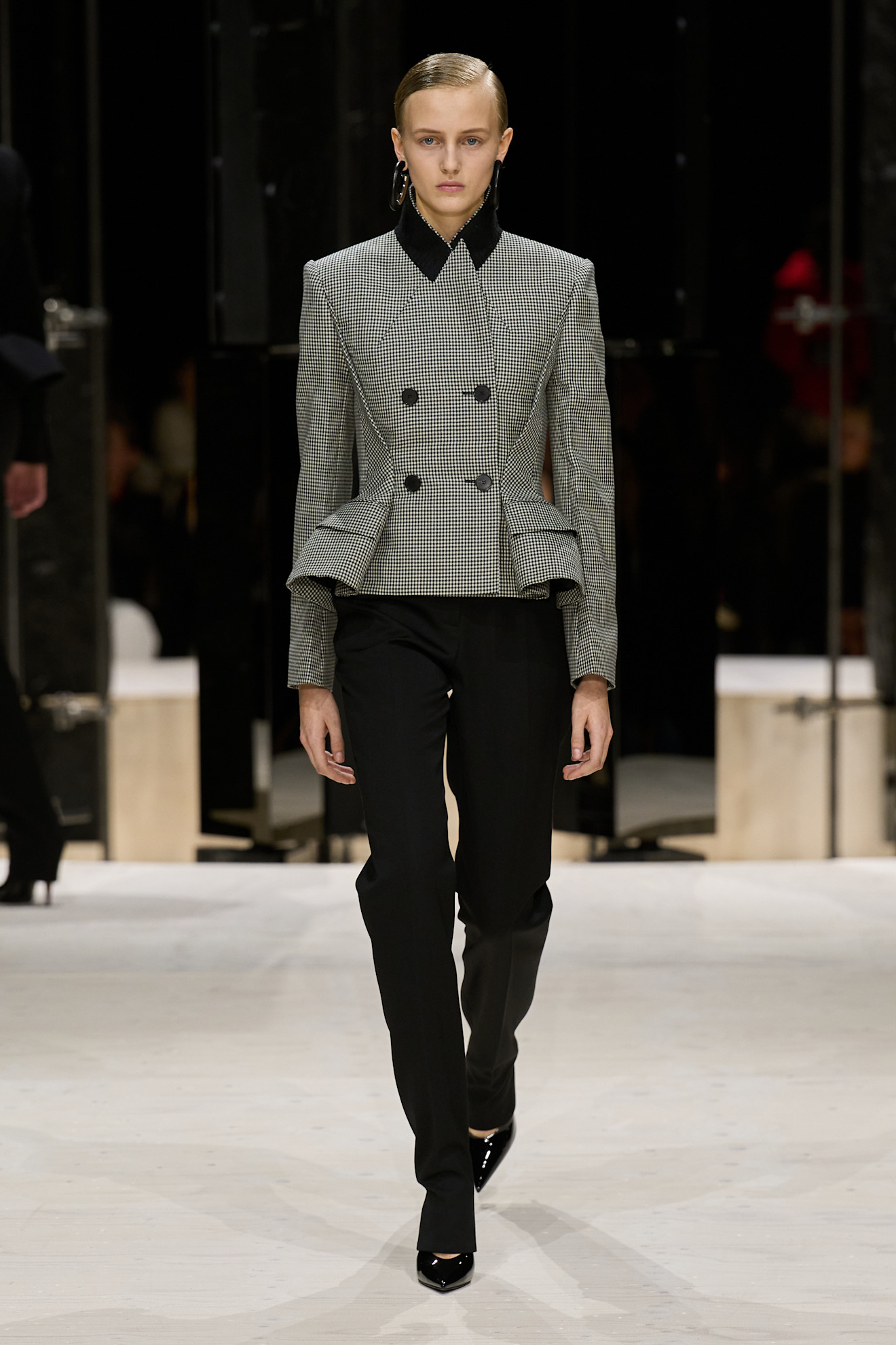 a model wears a tailored look at the givenchy f/w 26 show.