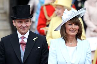 Michael and Carole Middleton smile at the crowds following the marriage of Prince William, Duke of Cambridge and Catherine, Duchess of Cambridge at Westminster Abbey on April 29, 2011