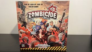 Zombicide box featuring stylized art of survivors fighting zombies