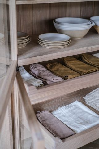 pantry shelving with crockery and napkins