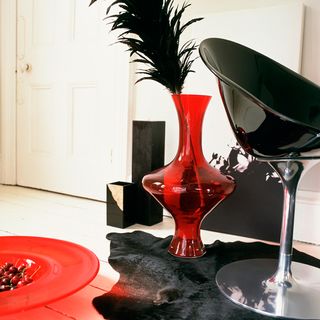 scandi black chair with vase and red plat