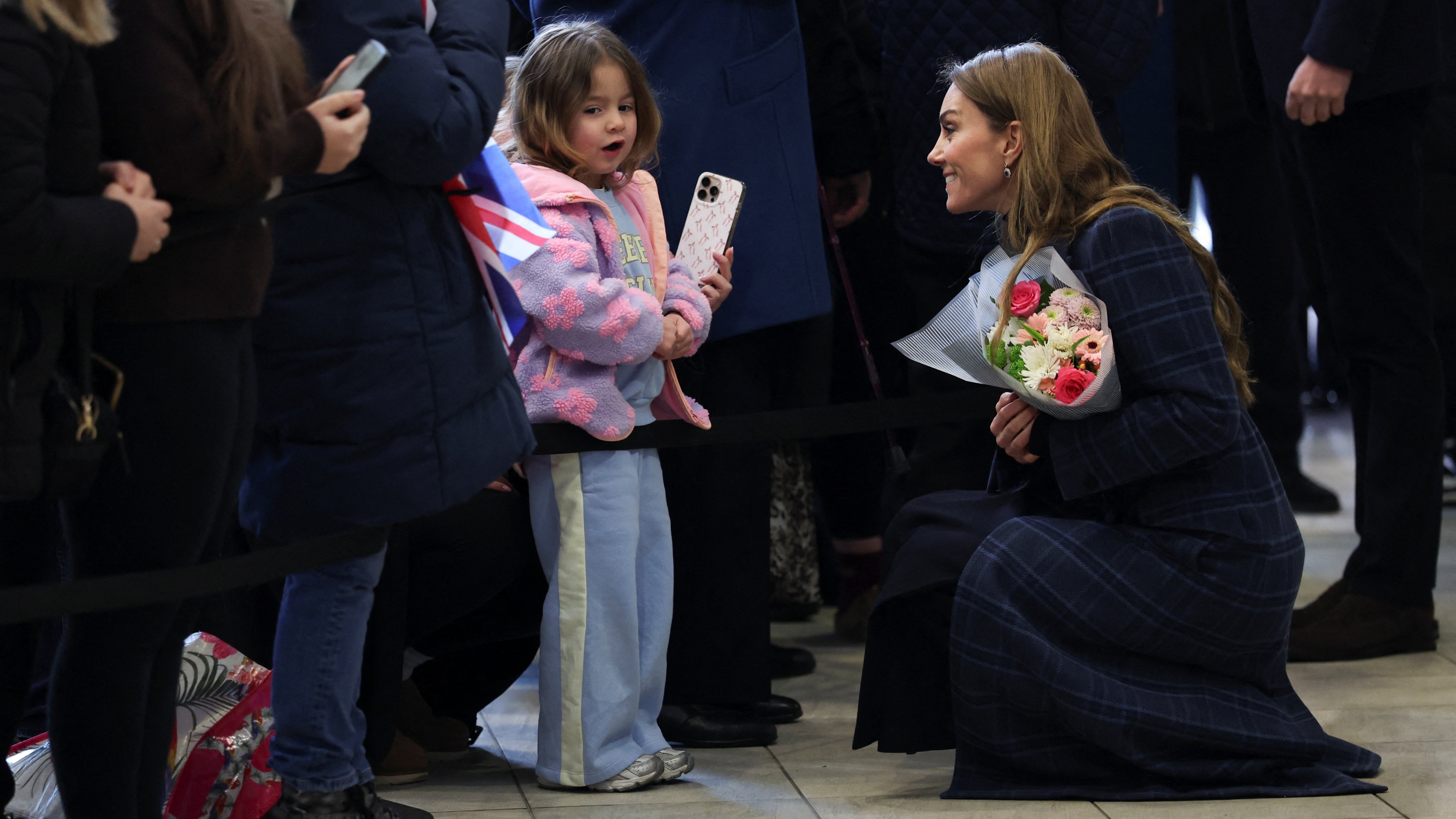 Catherine, Princess of Wales speaks to a child while visiting the National Curling Academy ahead of the Winter Olympic Games on January 20, 2026