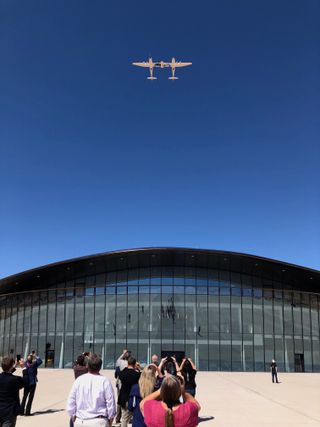 Virgin Galactic's VMS Eve carrier aircraft flies over the company's "Gateway to Space" building at Spaceport America in New Mexico on Aug. 15, 2019.