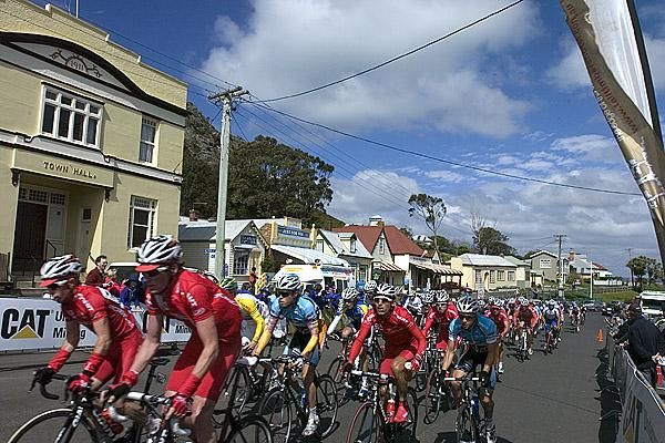 The chasing peloton pass through the main street of Stanley.