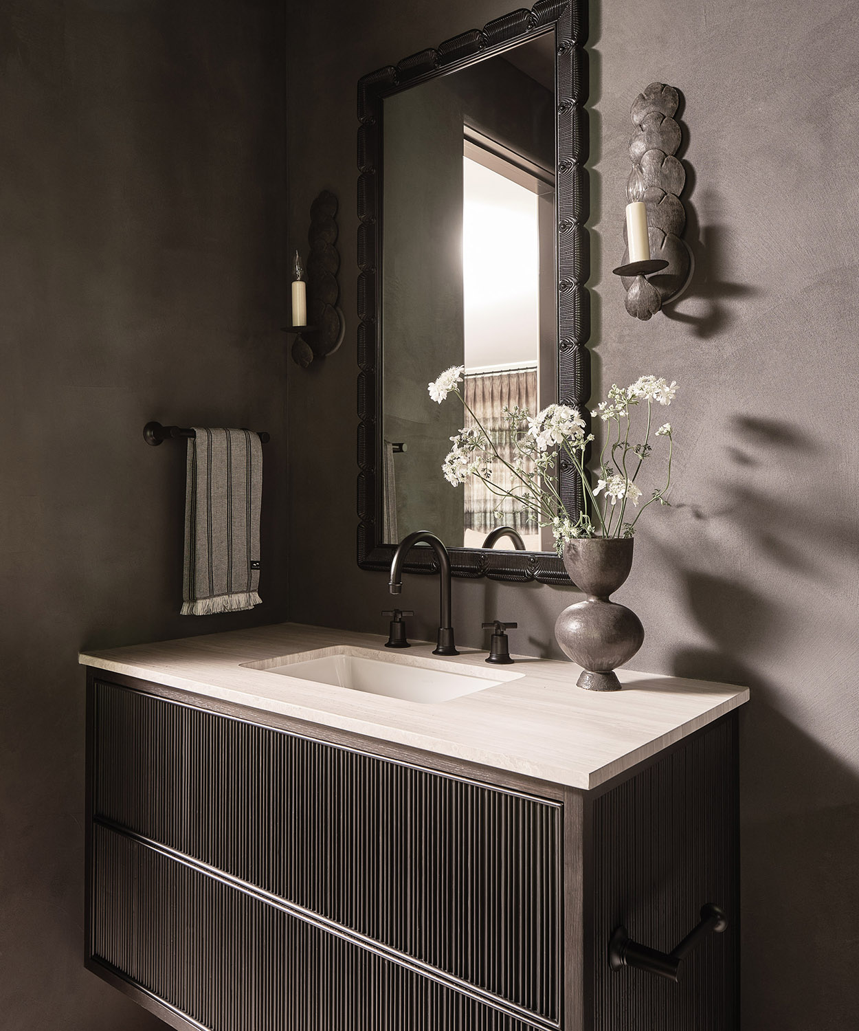 gray bathroom with gray vase on the vanity