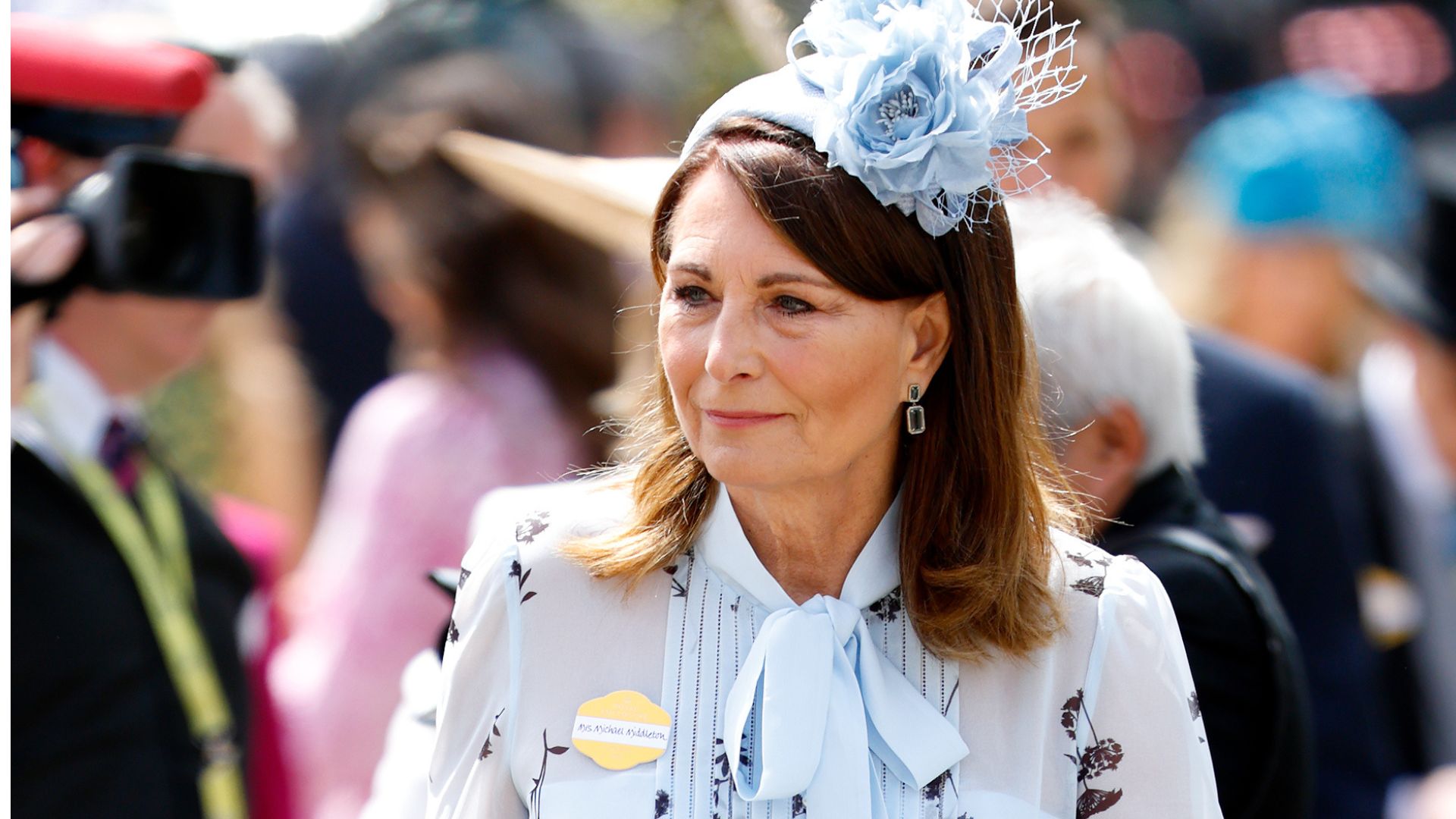 Carole Middleton wearing a floral dress and a headpiece