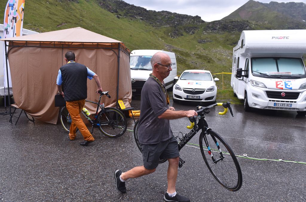 The UCI officials try to stay dry as they conduct the tests for hidden motors at Andorra-Arcalis