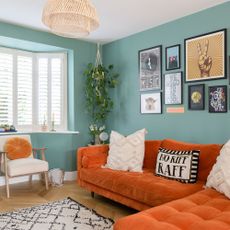 green living room with orange sofa