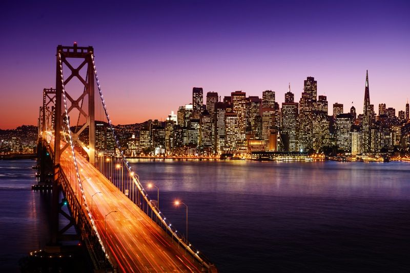 San Francisco skyline and Bay Bridge at sunset, California