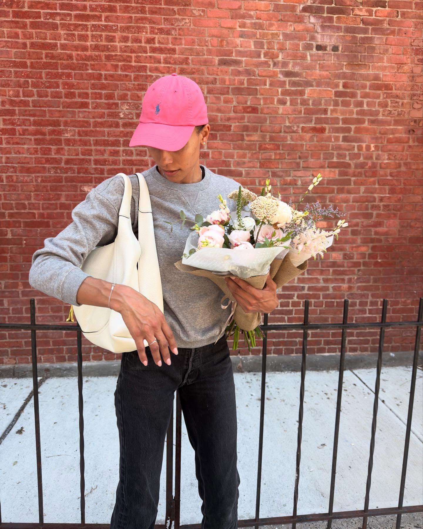 Woman showing how a fashion person wears a Polo baseball hat.