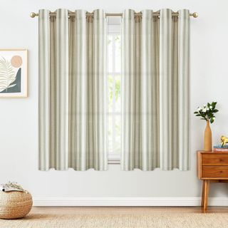 Green and white striped curtains on a living room window