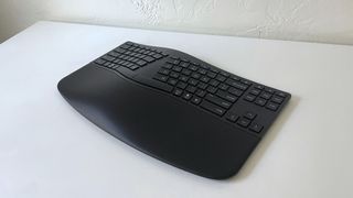 The HP 960 Ergonomic Keyboard on a white desk