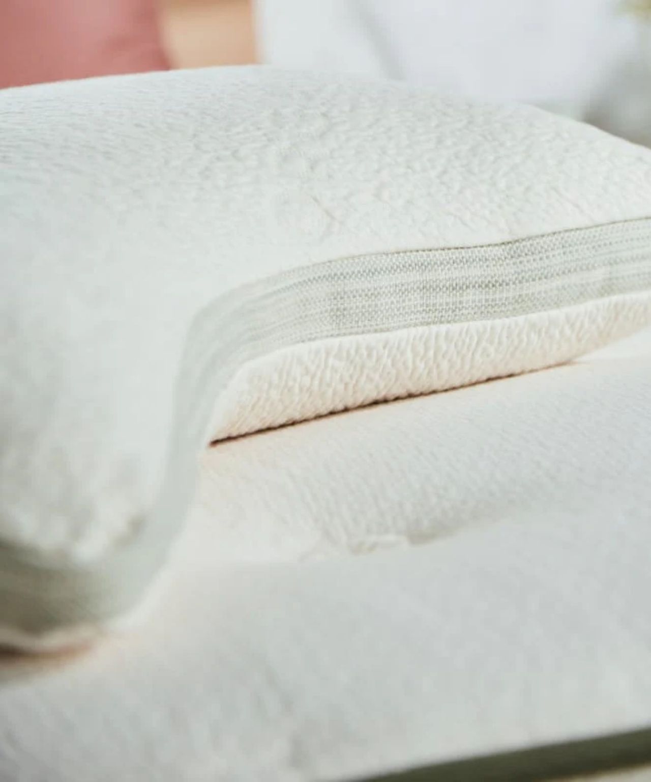 Avocado side sleeper green pillow on a white mattress