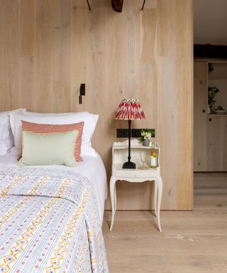 bedroom with light wood planks on walls and floors