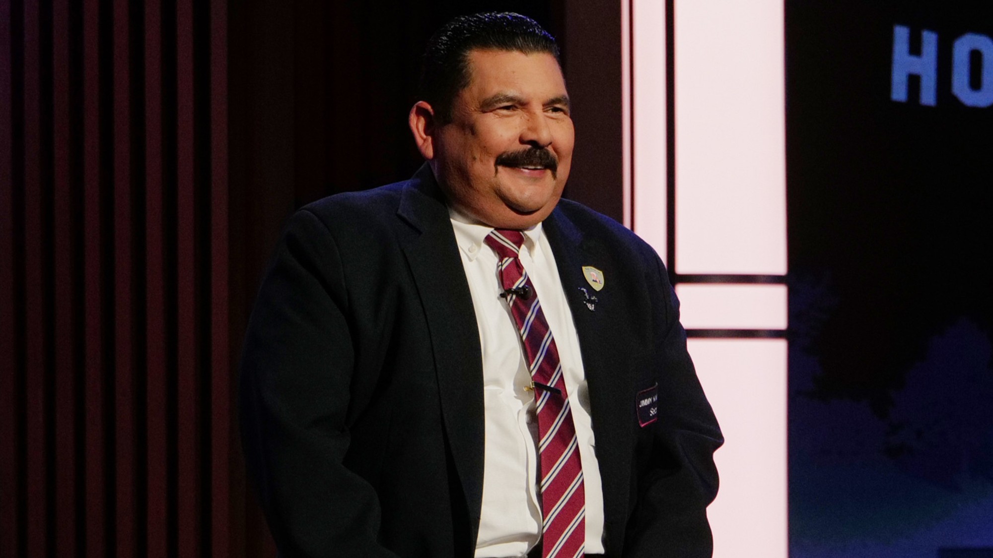 Guillermo Rodriguez sitting and smiling on Dancing with the Stars. 
