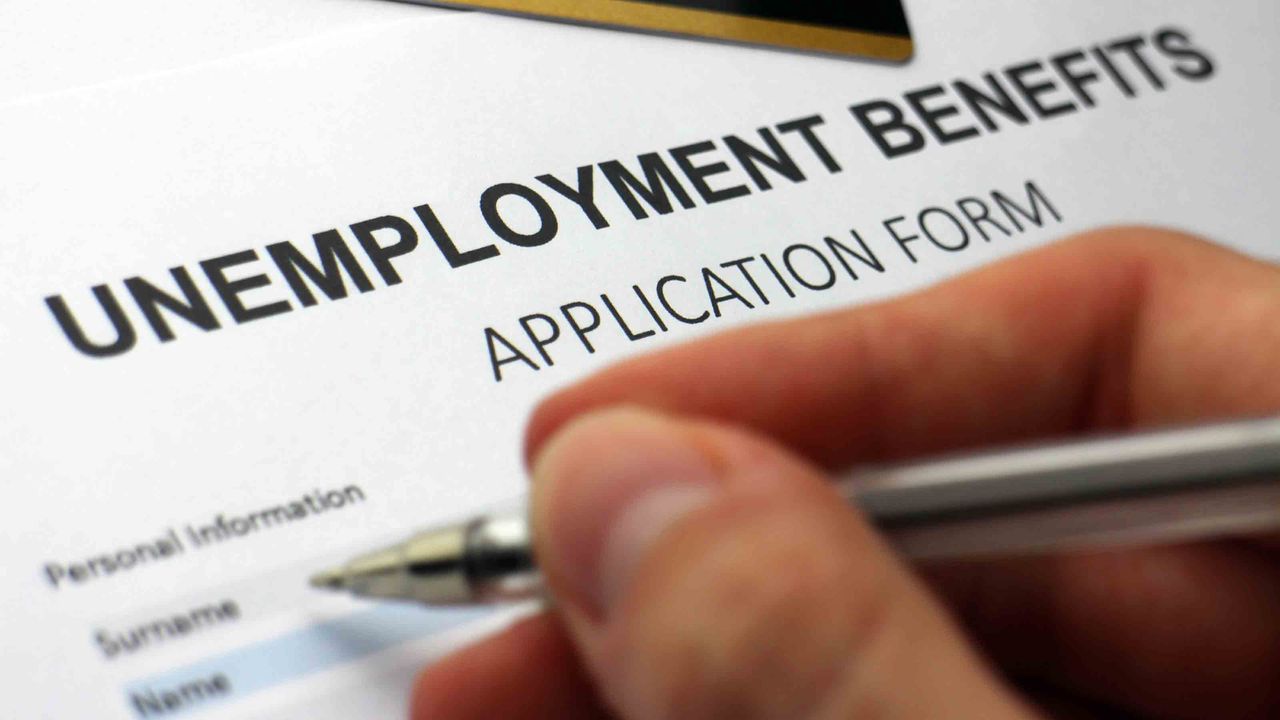 A person filling out an unemployment benefits form