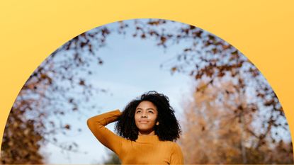 September astrology events feature; a woman in a yellow turtleneck under colored leaves on a fall day on a yellow background