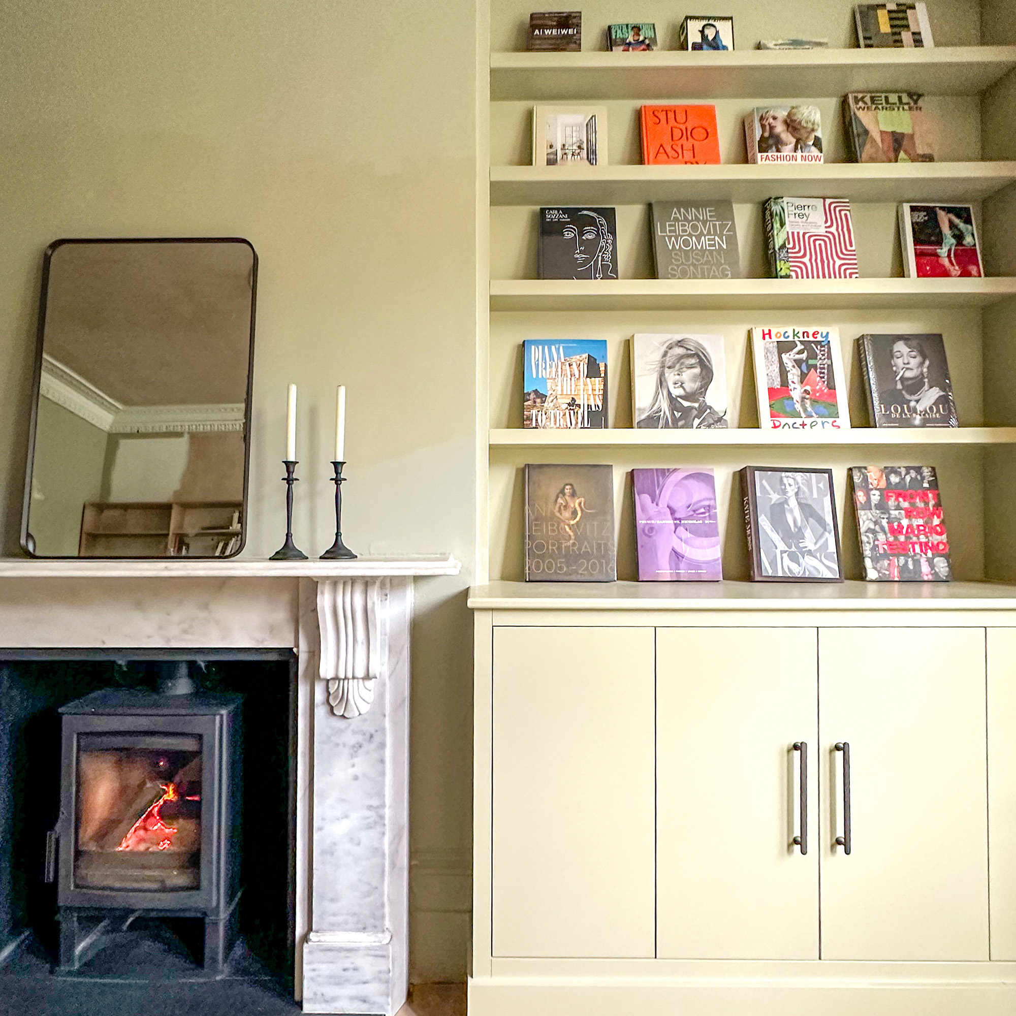 living room with fireplace and bookshelves