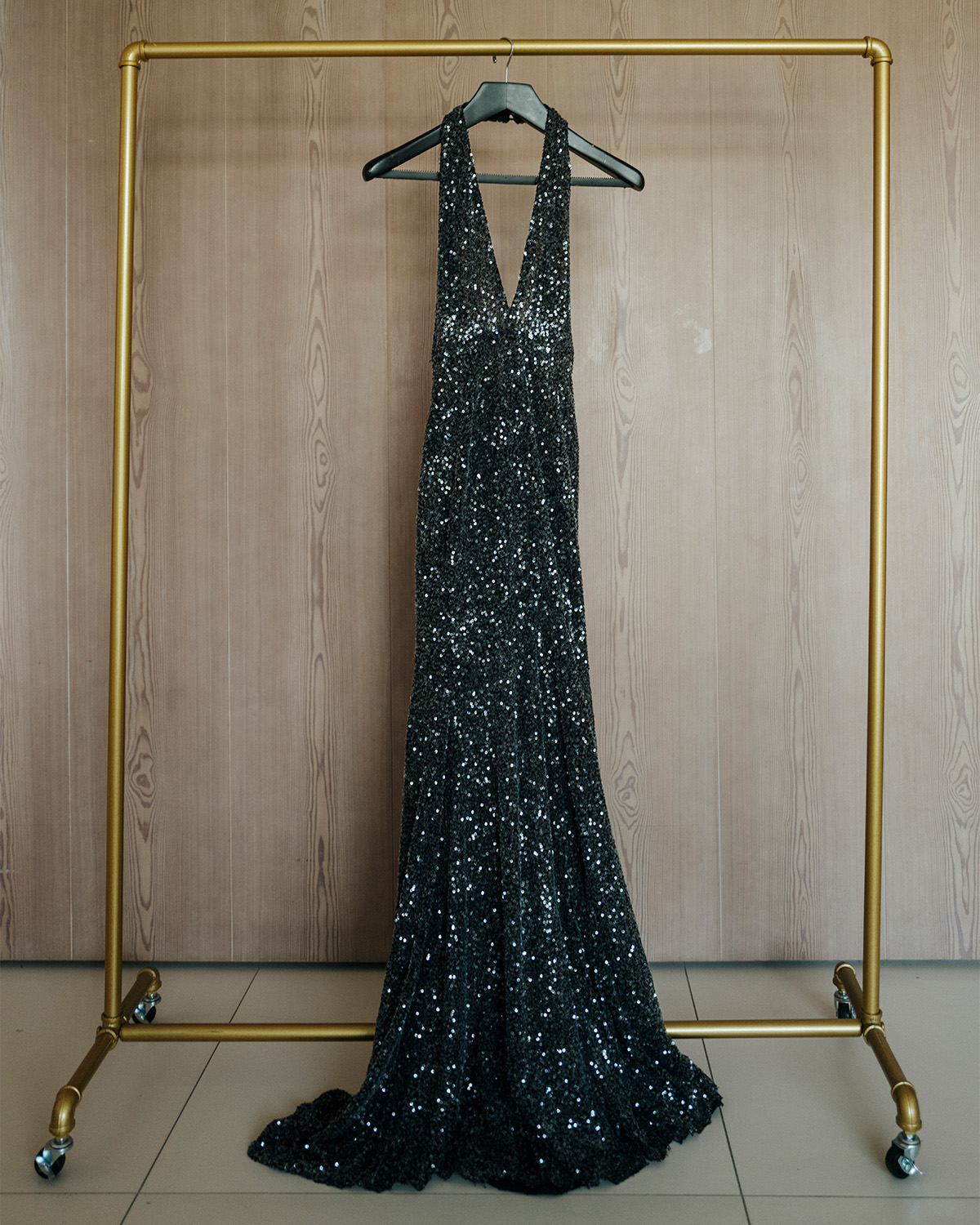 Lydia Peckham's Patou black sequin gown hanging solo on a rack.
