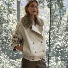 Woman in faux-fur lined trench coat