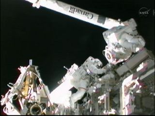 Sunita Williams and Akihiko Hoshide prepare space station robotic arm on Sept. 5, 2012.