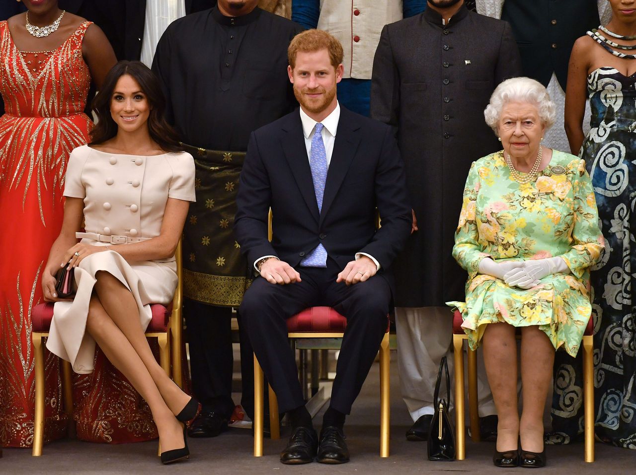 LONDON, ENGLAND - JUNE 26: Meghan, Duchess of Sussex, Prince Harry, Duke of Sussex and Queen Elizabeth II at the Queen&#039;s Young Leaders Awards Ceremony at Buckingham Palace on June 26, 2018 in London, England. The Queen&#039;s Young Leaders Programme, now in its fourth and final year, celebrates the achievements of young people from across the Commonwealth working to improve the lives of people across a diverse range of issues including supporting people living with mental health problems, access to education, promoting gender equality, food scarcity and climate change. (Photo by John Stillwell - WPA Pool/Getty Images)