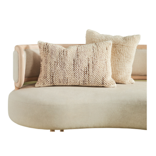 A cushion with tufted pillows 