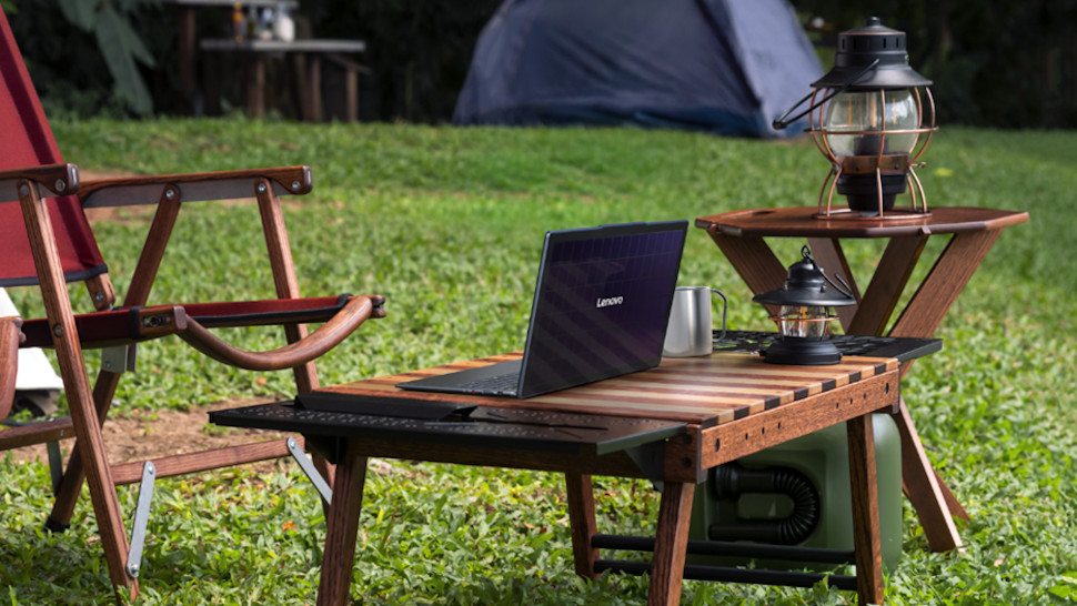 Lenovo Yoga Solar PC on a low table in a campsite