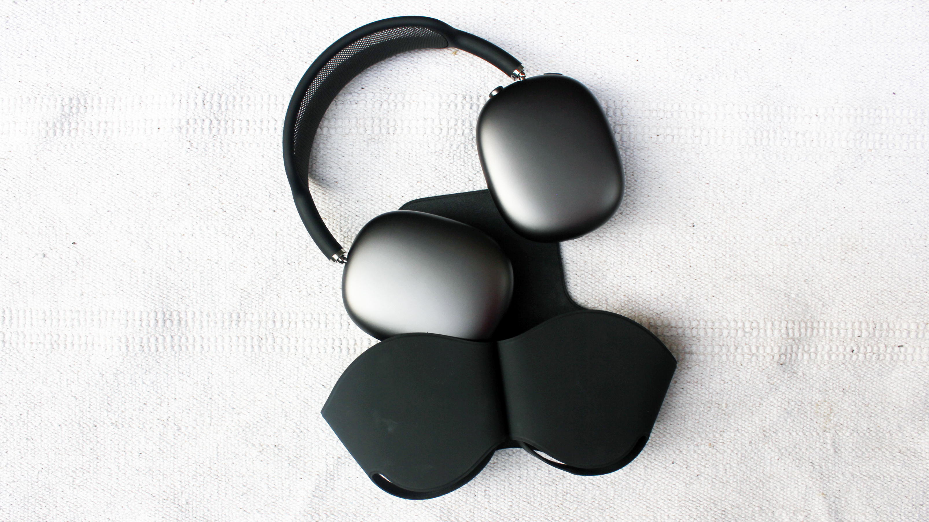 Black AirPods Max beside its case