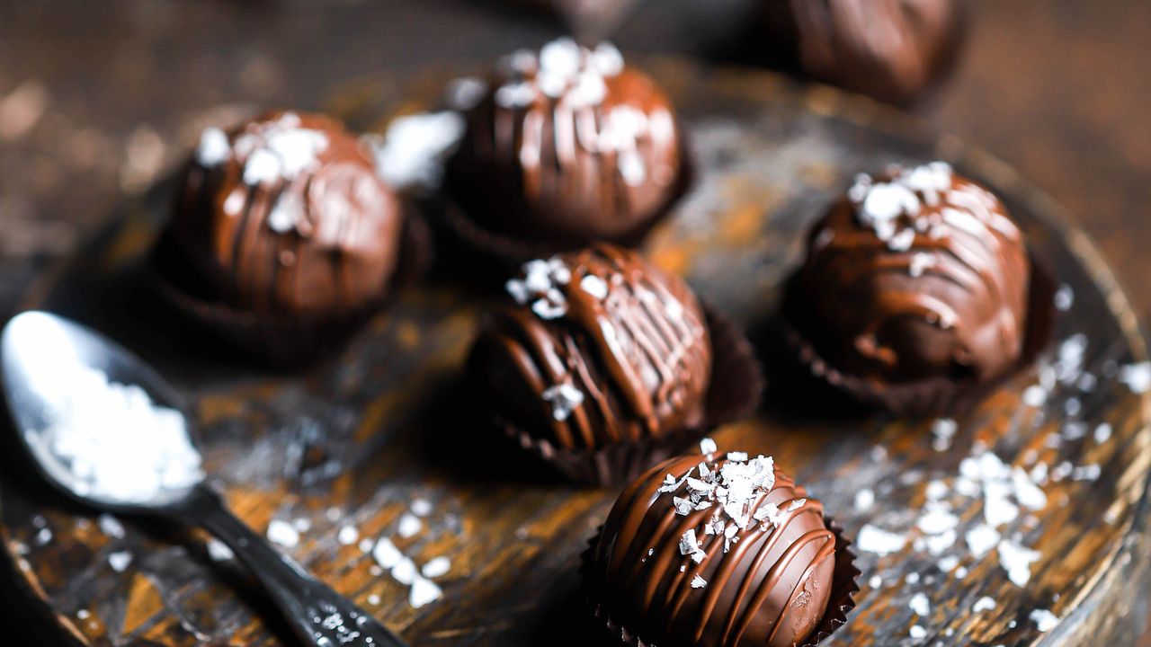 Salted caramel protein bites on a serving tray next to a spoon