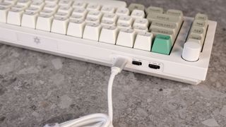 A shell white Keychron Q65 Max wireless mechanical keyboard