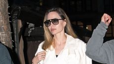 Angelina Jolie's trench coat and white Valentino bag is perfection