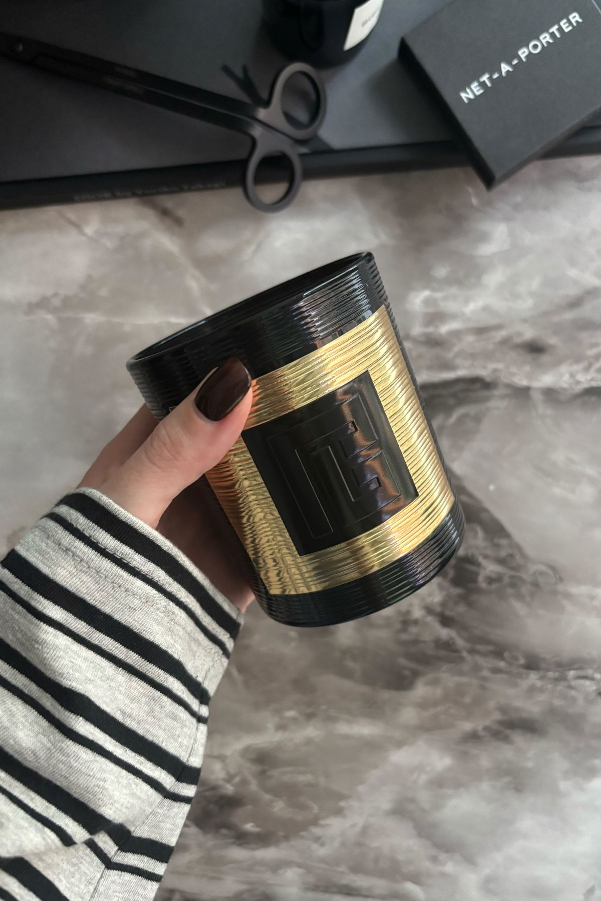 Deputy beauty editor Grace Lindsay holding the Balmain Rouge Candle