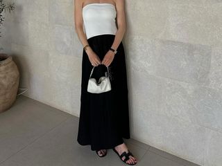 @annabelrosendahl wearing a strapless dress and Hermes Oran sandals.