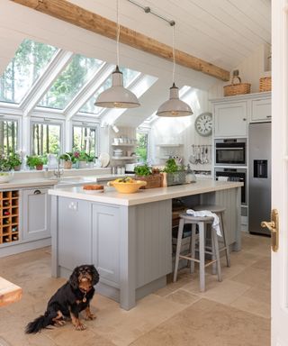 kitchen extension with vaulted ceiling, panelling, roof lights and pale blue kitchen island