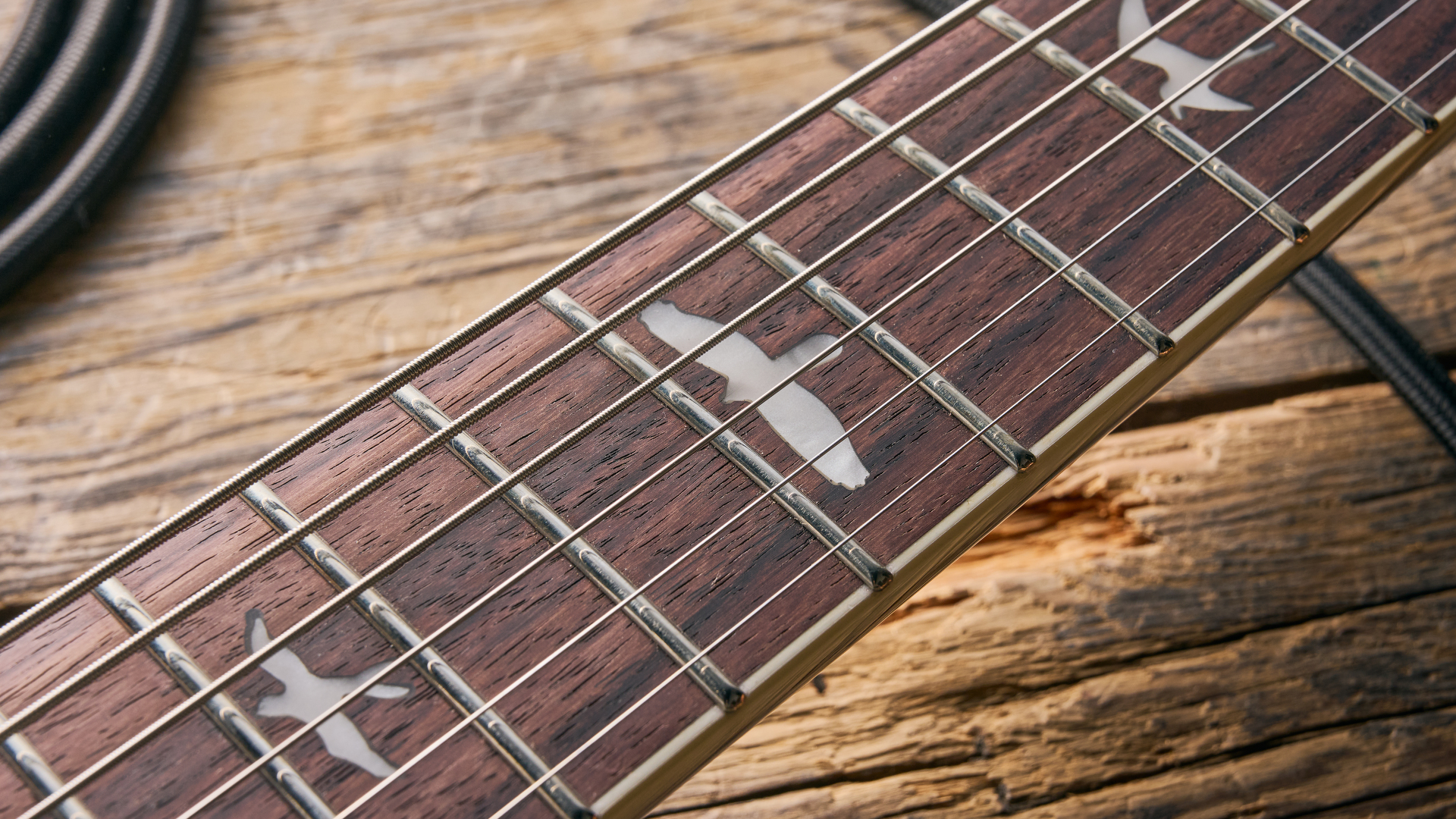 The rosewood fretboard of the PRS SE Ed Sheeran Hollowbody I Piezo Baritone guitar