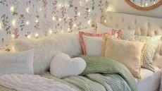 Dorm bed with pillows and string lights