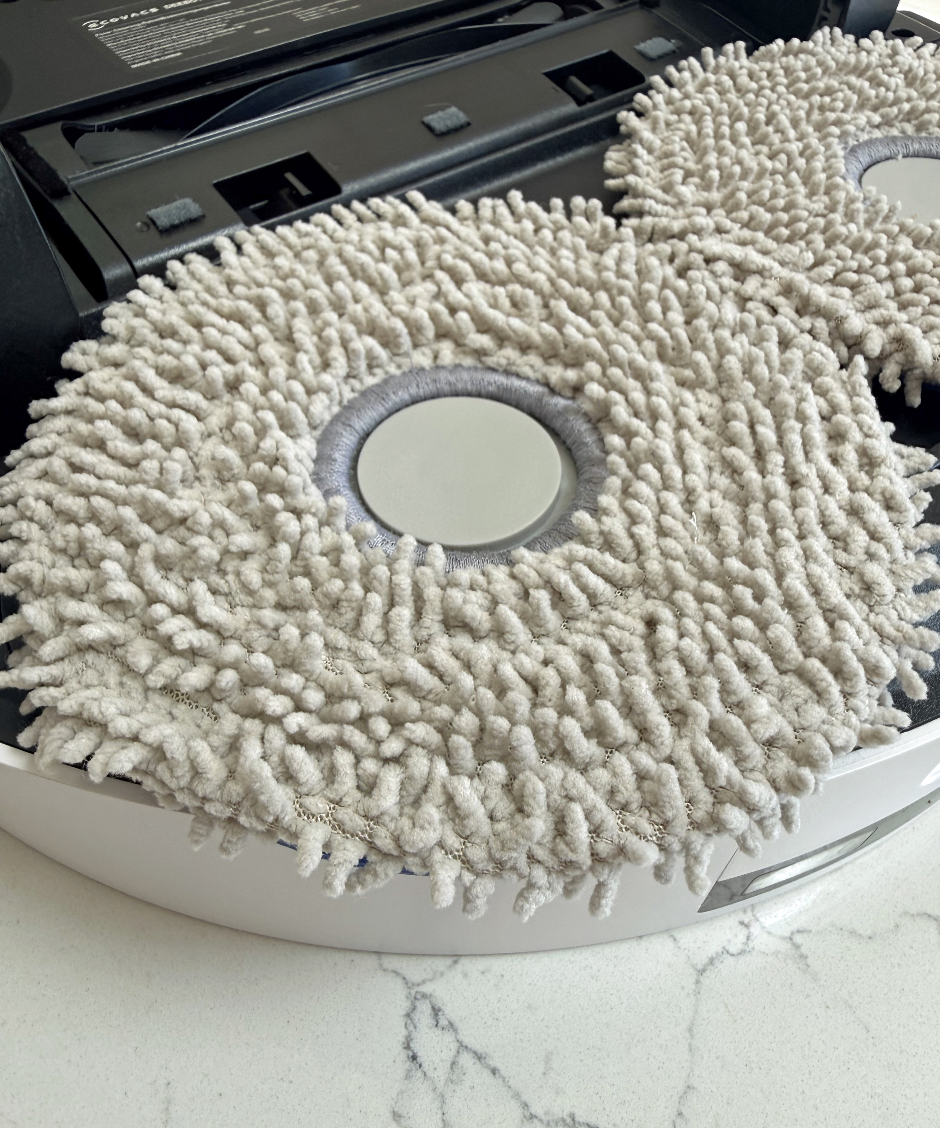Close-up of one of the removable microfibre spinning mop pads on the Ecovacs Deebot T50 Pro Omni