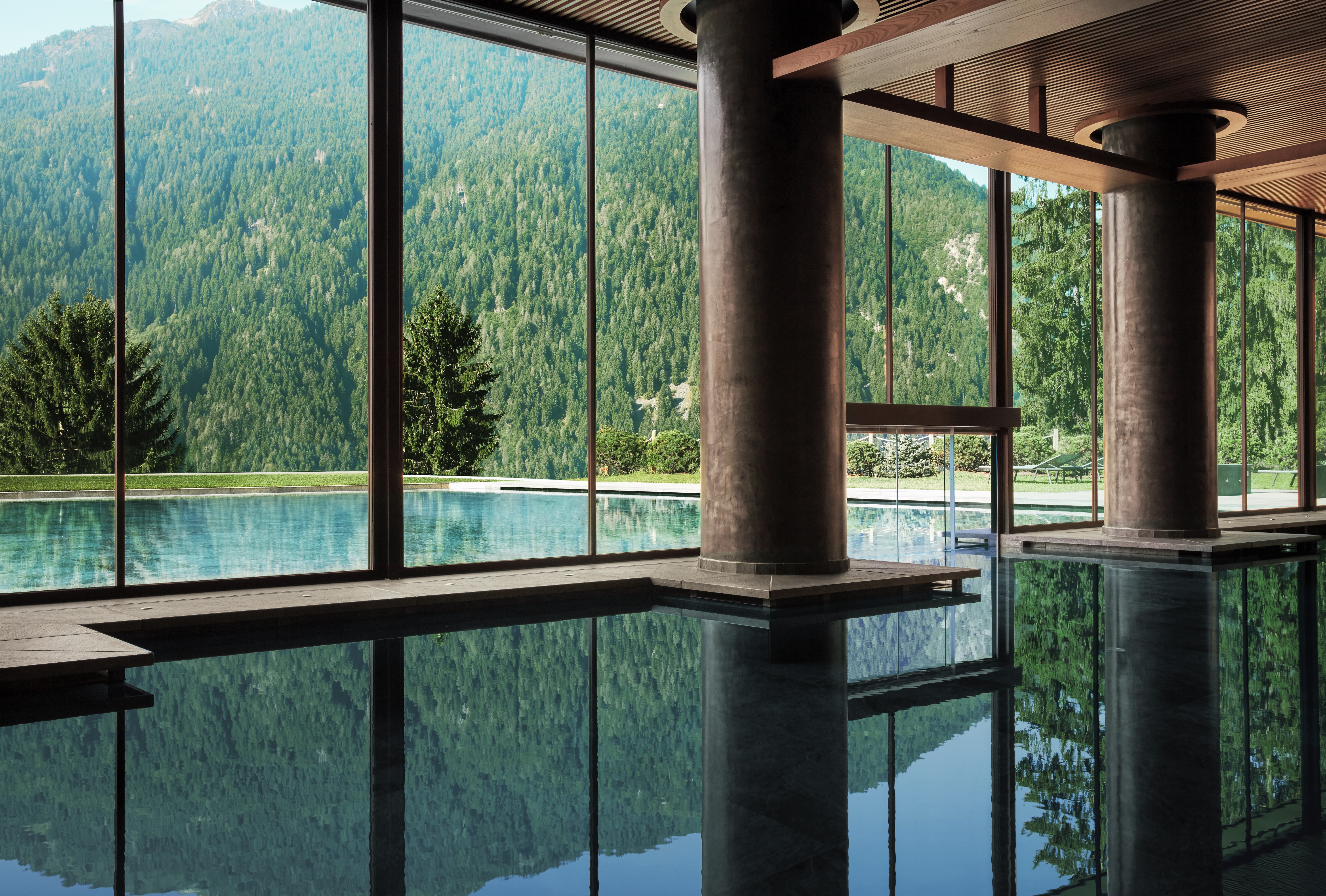 The indoor-outdoor pool at Lefay Resort &amp;amp; Spa Dolomiti during summer