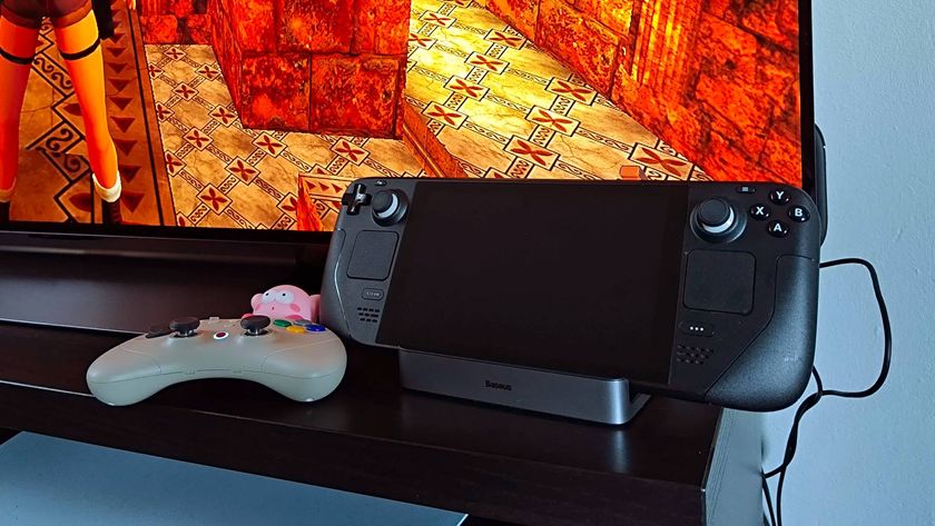 Steam Deck LCD model hooked up to Baseus docking station next to Gulikit Elves 2 Pro controller with LG OLED TV in backdrop.