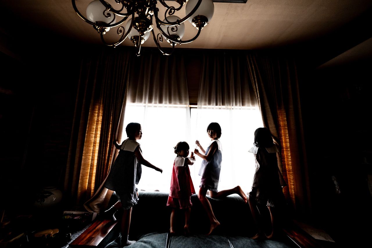 Children playing on sofa.