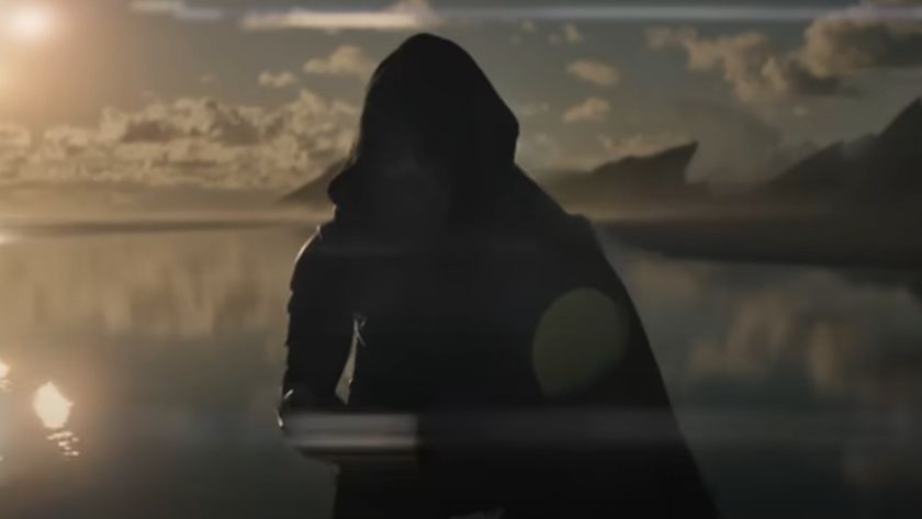 A Predator standing before water in Predator: Badlands