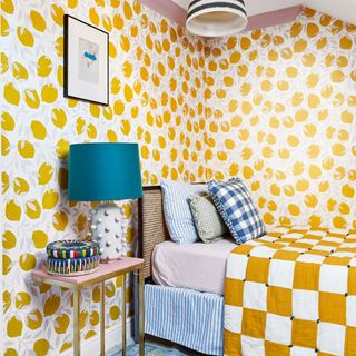 Bedroom with lemon print wallpaper and yellow and white check bedspread