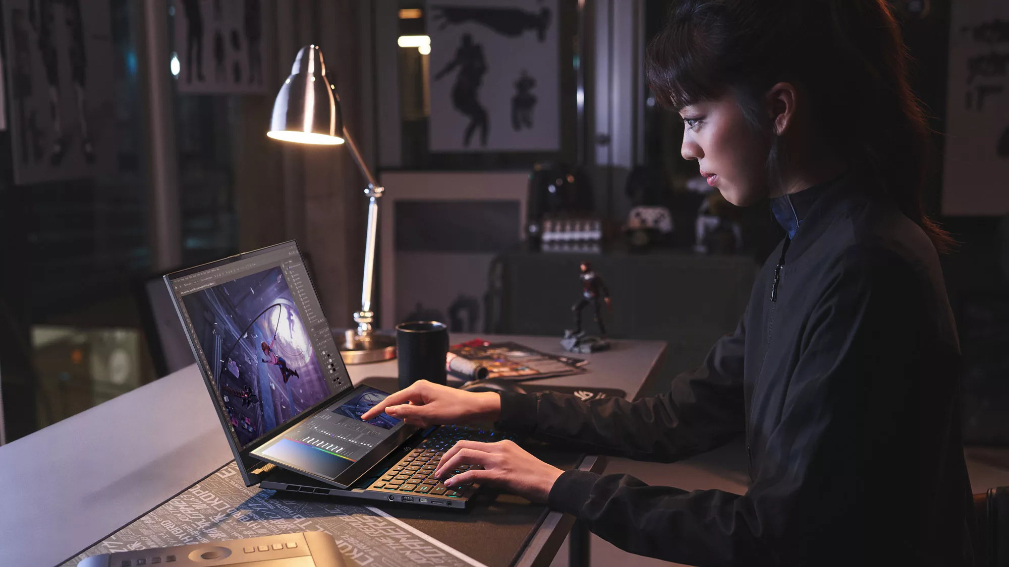 A person using the lower touchscreen on the Asus ROG Zephyrus Duo 16 laptop.
