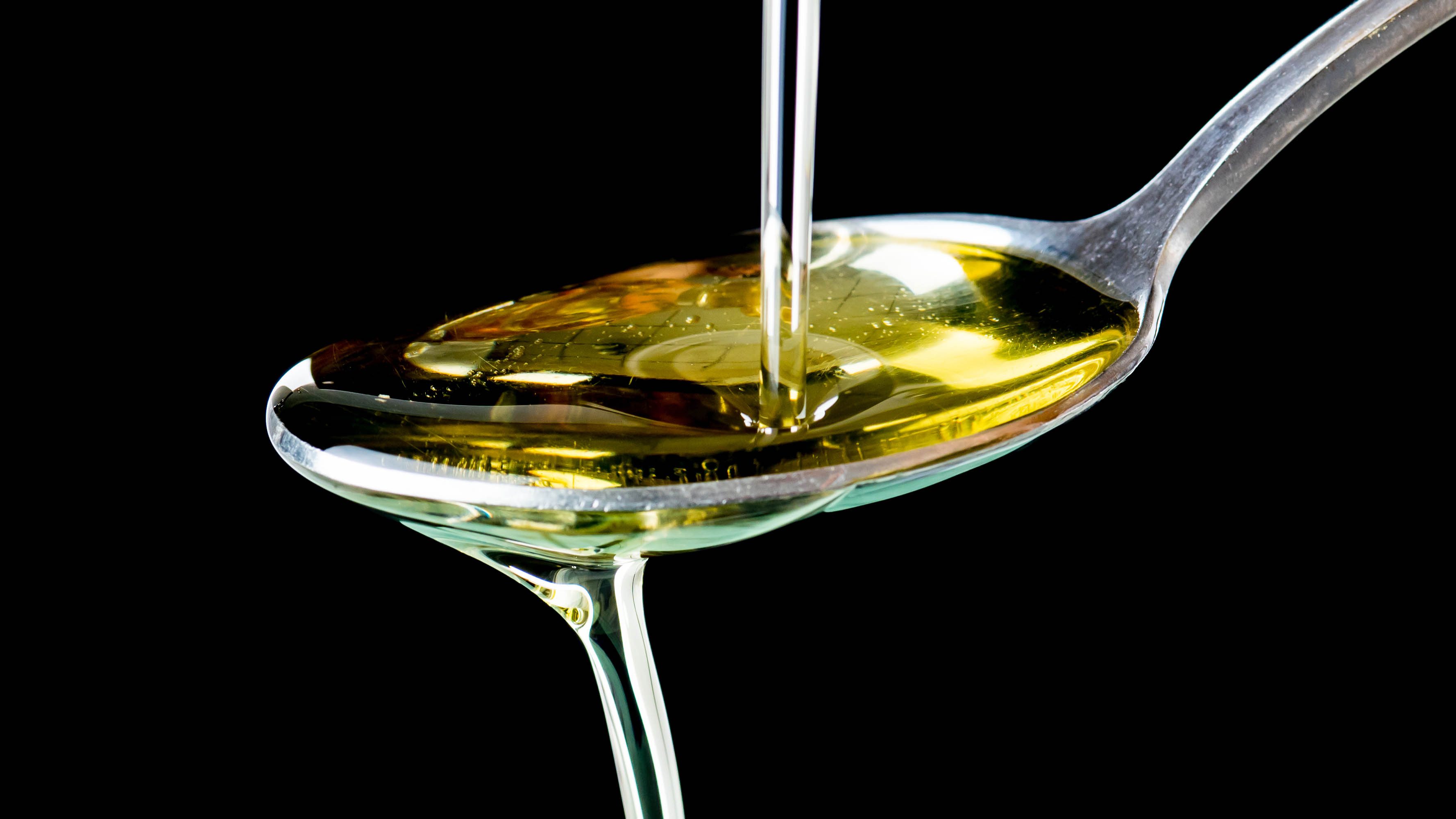 Oil being poured into a spoon