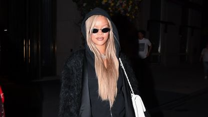 Rihanna wearing an all-black outfit and a white Chanel purse while in New York City May 2024