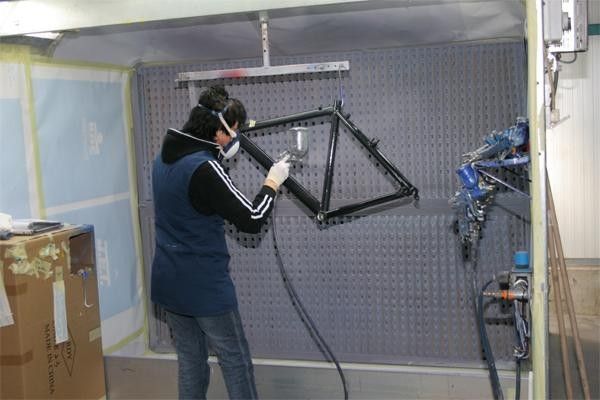 Several workers dedicate themselves to the painting of the frames