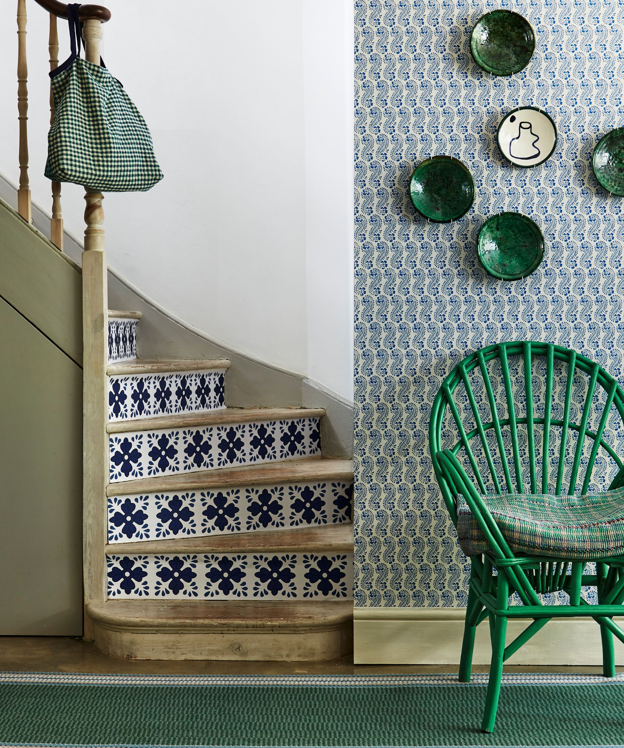 Statement green entryway and tiled staircase