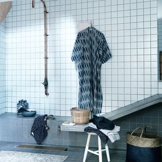 blue and white wetroom with brass fittings