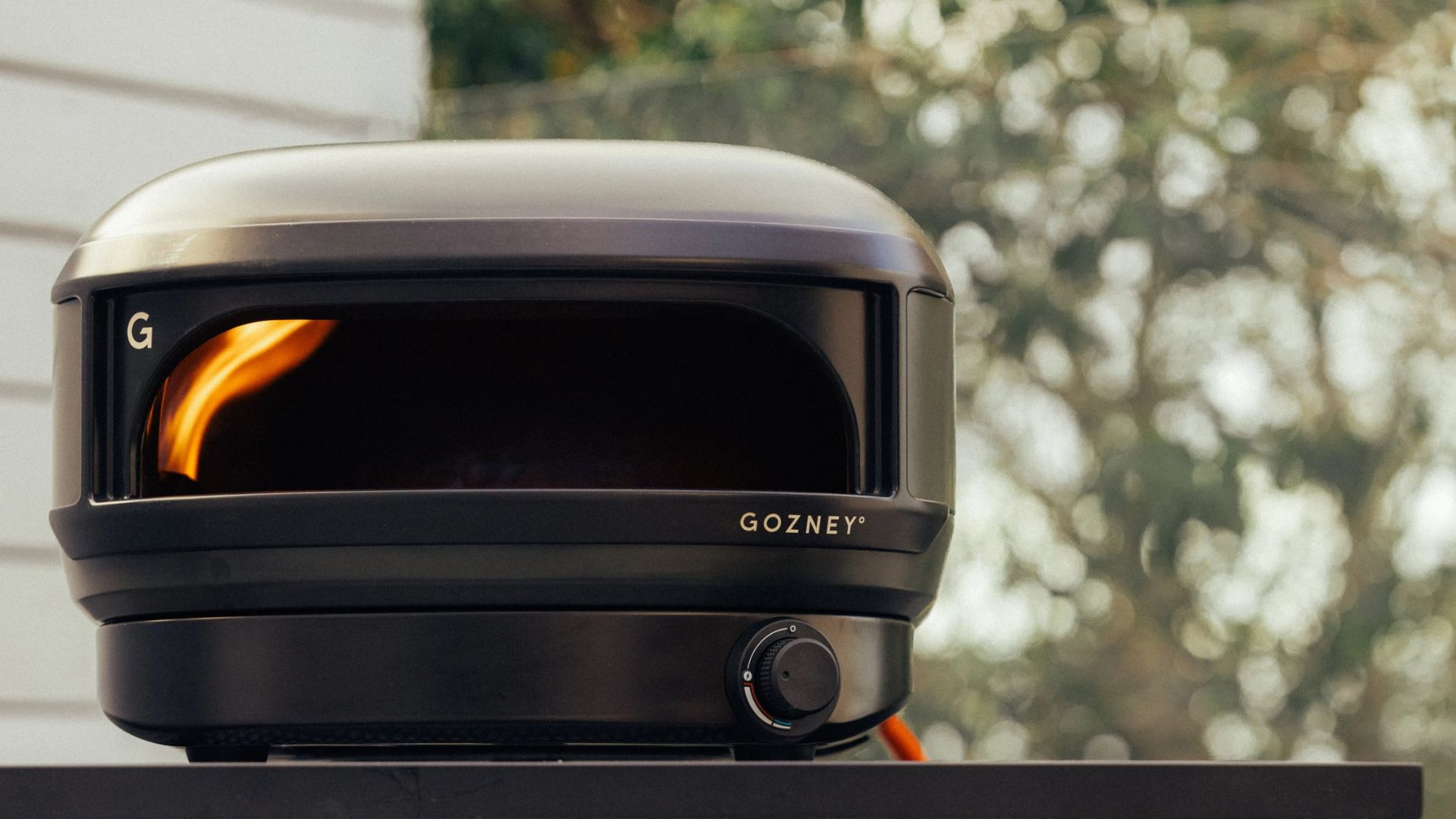 The Gozney Arc Lite Pizza Oven in an outdoor setting with the fire running
